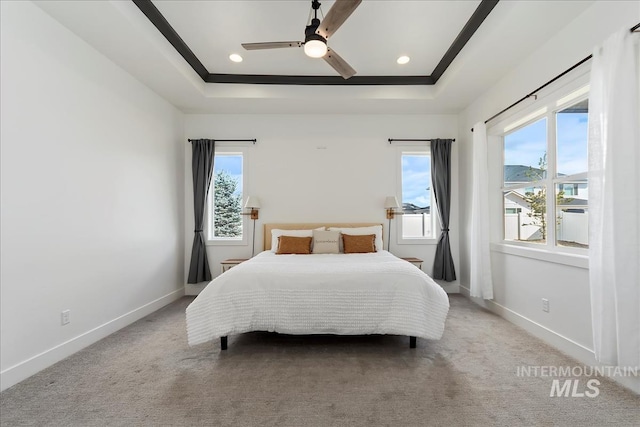 bedroom with carpet floors, recessed lighting, a raised ceiling, and baseboards