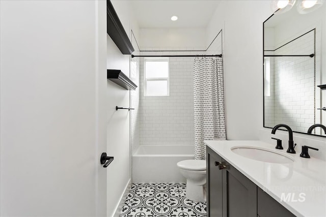 full bathroom featuring shower / tub combo, tile patterned flooring, vanity, and toilet