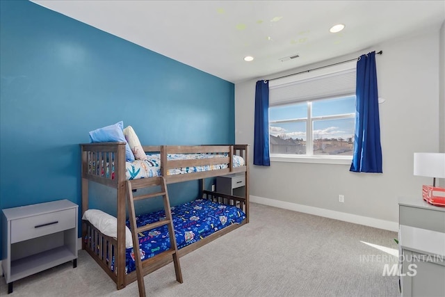 carpeted bedroom featuring baseboards, visible vents, and recessed lighting