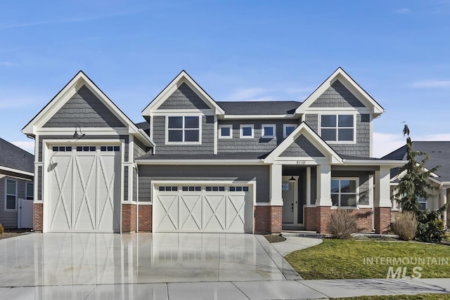 view of front of house with concrete driveway, brick siding, and a front lawn