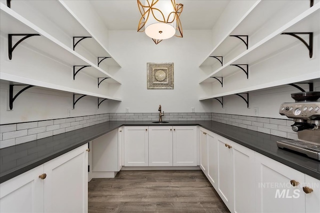 kitchen with dark countertops, dark wood finished floors, and open shelves