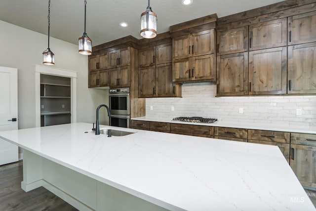 275 Meadow View Dr, Payette, ID 83661 - kitchen with stainless steel appliances, tasteful backsplash, dark wood-style floors, light stone countertops, and hanging light fixtures