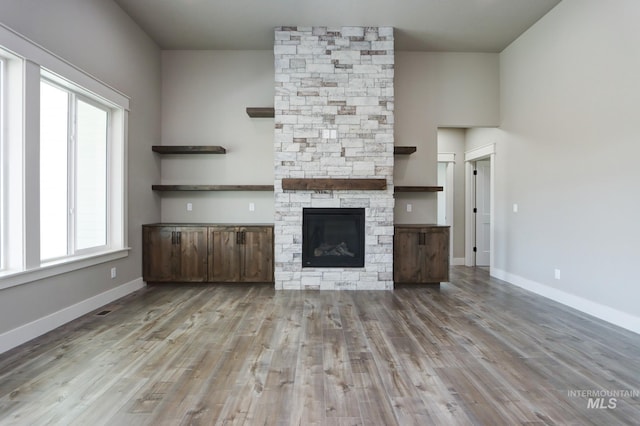 275 Meadow View Dr, Payette, ID 83661 - unfurnished living room with wood finished floors and a stone fireplace