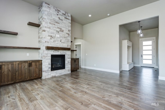 275 Meadow View Dr, Payette, ID 83661 - unfurnished living room with wood finished floors and a stone fireplace