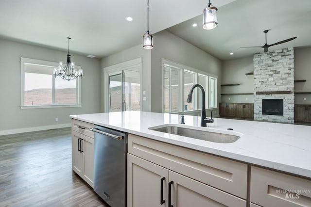 275 Meadow View Dr, Payette, ID 83661 - kitchen featuring dishwasher, a ceiling fan, light stone counters, hanging light fixtures, and light wood finished floors