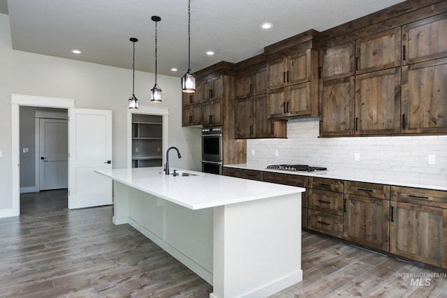 275 Meadow View Dr, Payette, ID 83661 - kitchen with tasteful backsplash, stainless steel appliances, wood finished floors, light countertops, and recessed lighting