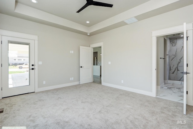 275 Meadow View Dr, Payette, ID 83661 - unfurnished bedroom with recessed lighting, a tray ceiling, carpet, ensuite bathroom, and ceiling fan