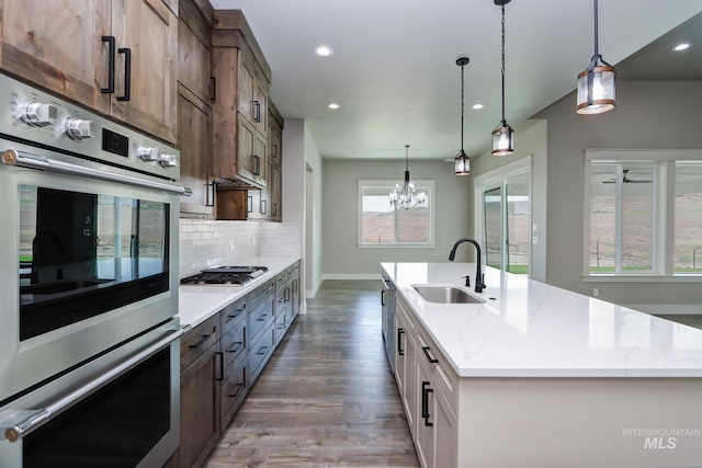 275 Meadow View Dr, Payette, ID 83661 - kitchen featuring appliances with stainless steel finishes, wood finished floors, recessed lighting, an island with sink, and tasteful backsplash