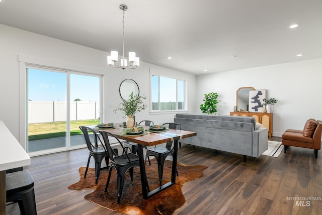 dining area featuring a chandelier, dark wood-type flooring, and recessed lighting