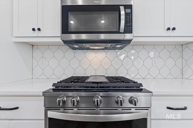 19322 N Shepherds Pie Pl, Boise, ID 83714 - kitchen featuring appliances with stainless steel finishes, light countertops, white cabinets, and tasteful backsplash