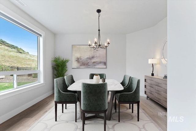 19322 N Shepherds Pie Pl, Boise, ID 83714 - dining space featuring a chandelier, plenty of natural light, light wood-style flooring, and baseboards
