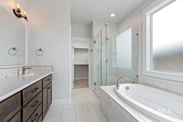 19322 N Shepherds Pie Pl, Boise, ID 83714 - full bathroom featuring a shower stall, a spacious closet, marble look tiles, a bath, and baseboards