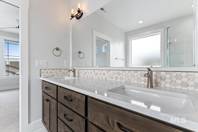 19322 N Shepherds Pie Pl, Boise, ID 83714 - bathroom featuring backsplash, double vanity, and baseboards
