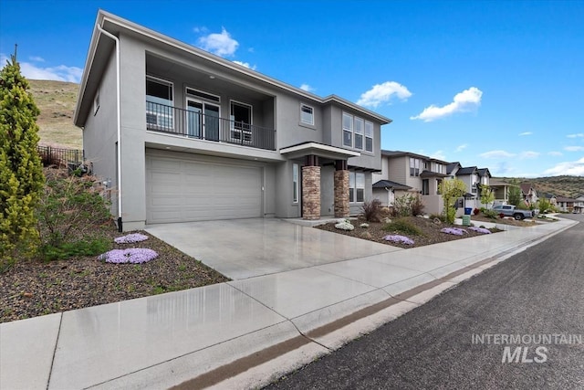 19322 N Shepherds Pie Pl, Boise, ID 83714 - view of front of house with a balcony, stucco siding, an attached garage, a residential view, and driveway
