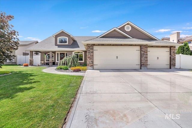 1021 Ballard Ln, Kimberly, ID 83341 - view of front of property featuring a garage, stone siding, driveway, and a shingled roof