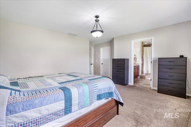 1021 Ballard Ln, Kimberly, ID 83341 - bedroom with light colored carpet and ensuite bath