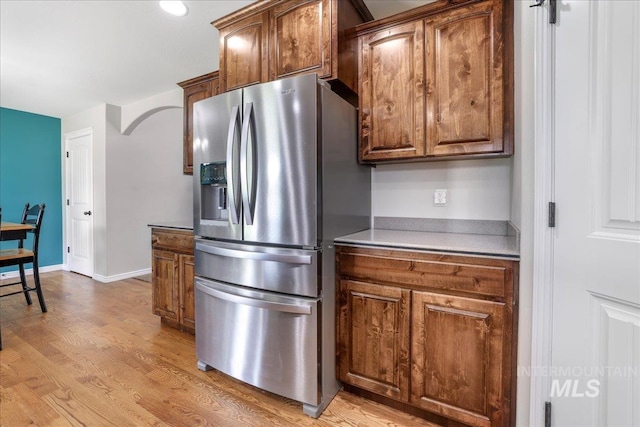 1021 Ballard Ln, Kimberly, ID 83341 - kitchen featuring stainless steel fridge with ice dispenser, light wood-style flooring, and brown cabinets