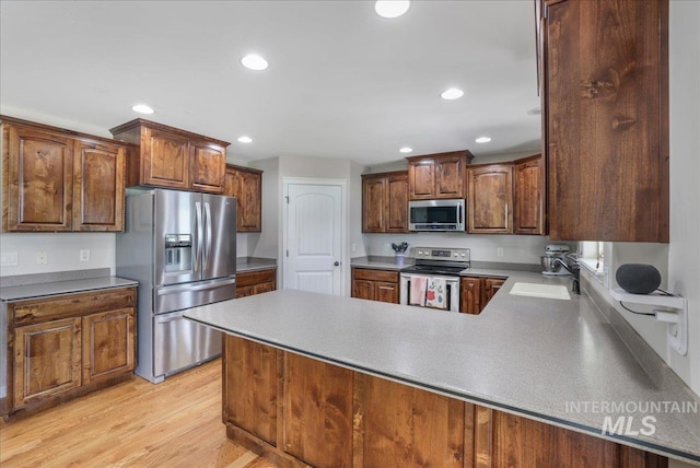1021 Ballard Ln, Kimberly, ID 83341 - kitchen with stainless steel appliances, recessed lighting, light wood-type flooring, and a peninsula