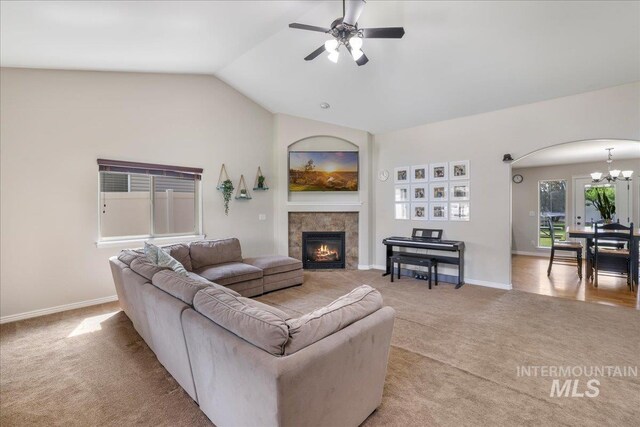 1021 Ballard Ln, Kimberly, ID 83341 - living area featuring arched walkways, light carpet, a chandelier, ceiling fan, and lofted ceiling