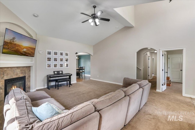 1021 Ballard Ln, Kimberly, ID 83341 - living area featuring arched walkways, high vaulted ceiling, a ceiling fan, light carpet, and a fireplace