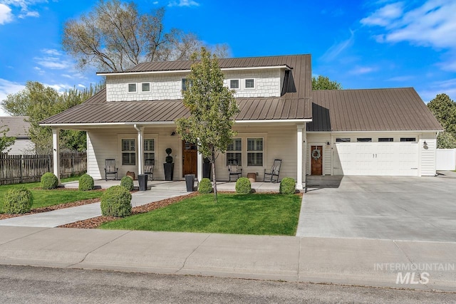 view of front of home with a front lawn, a porch, and a garage