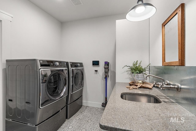 washroom featuring separate washer and dryer and sink