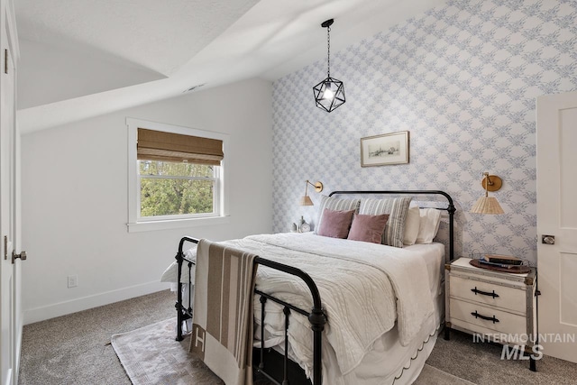 bedroom featuring dark carpet and lofted ceiling