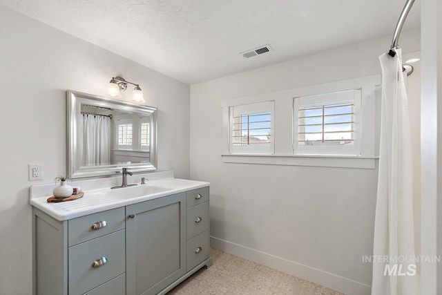 bathroom with vanity and a textured ceiling