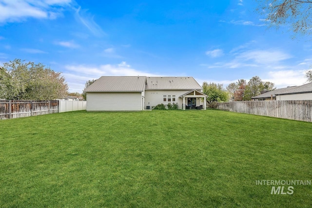 back of property featuring a lawn