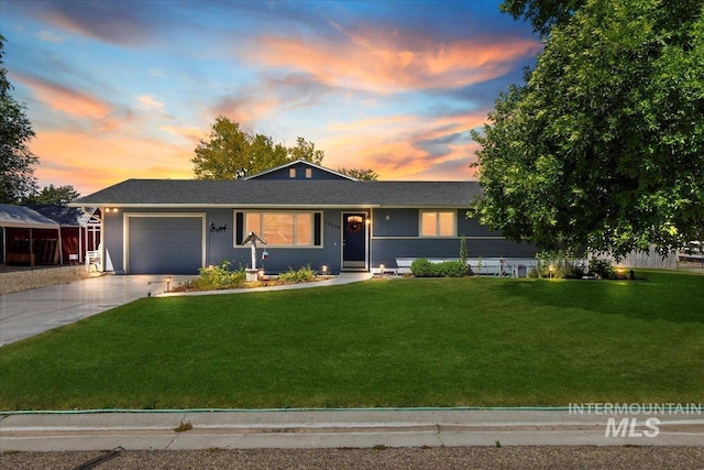 ranch-style house with a lawn and a garage