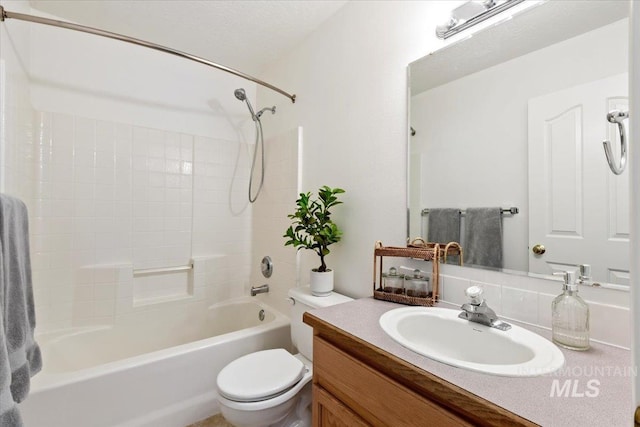 full bathroom featuring toilet, vanity, and shower / bathtub combination