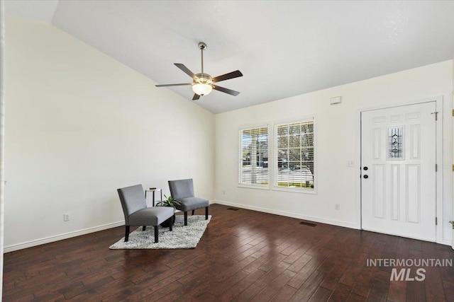 living area featuring vaulted ceiling, baseboards, hardwood / wood-style flooring, visible vents, and a ceiling fan