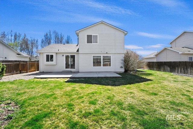 rear view of property with a patio, a fenced backyard, and a yard