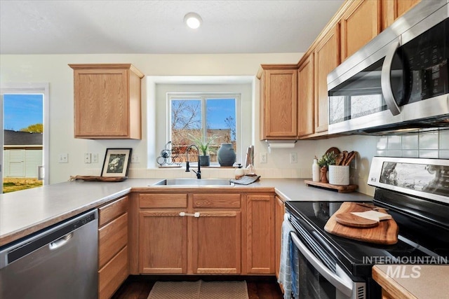 kitchen featuring light countertops, a sink, and appliances with stainless steel finishes