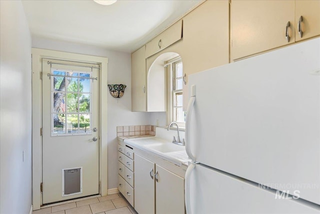 404 W 5th St, Weiser, ID 83672 - kitchen with freestanding refrigerator, a sink, light countertops, light tile patterned floors, and heating unit