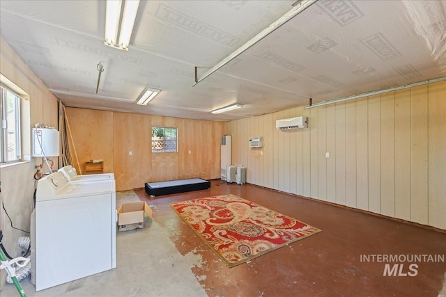 404 W 5th St, Weiser, ID 83672 - sitting room featuring washing machine and dryer, unfinished concrete flooring, a wall mounted AC, and wood walls