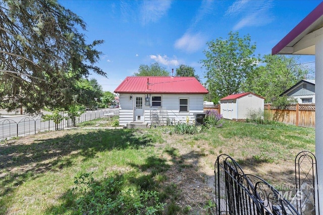 404 W 5th St, Weiser, ID 83672 - back of house with a fenced backyard and metal roof