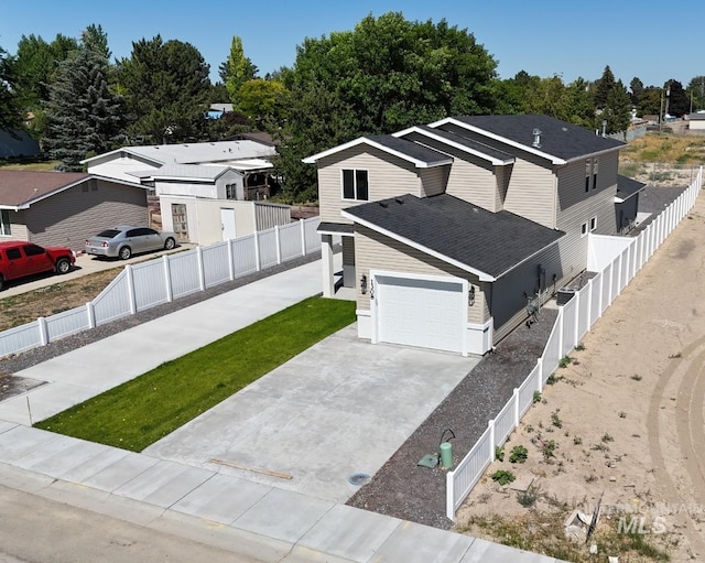 1308 N Buchanan Unit A & B, Jerome, ID 83338 - view of front of house with an attached garage, driveway, a shingled roof, and a fenced backyard