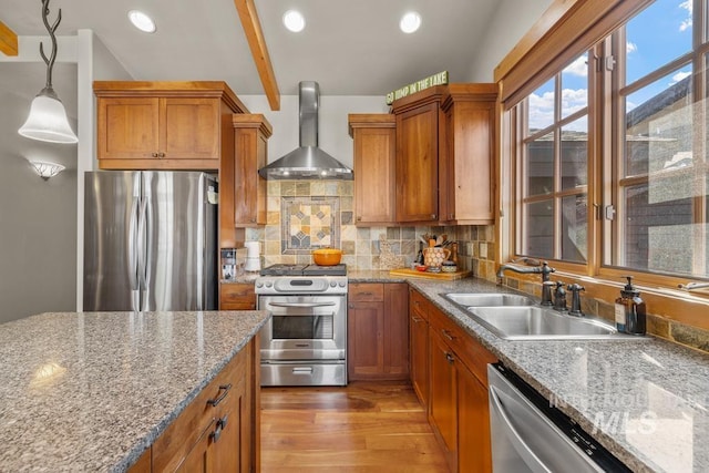 1391 Greystone Dr, Mccall, ID 83638 - kitchen featuring stainless steel appliances, wall chimney exhaust hood, a sink, brown cabinets, and recessed lighting