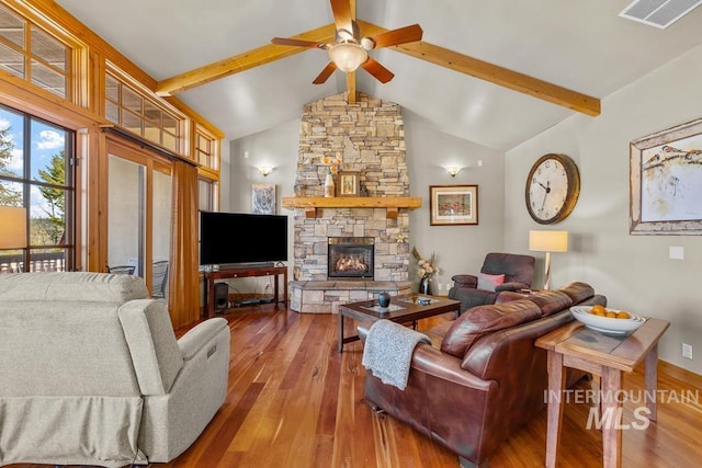 1391 Greystone Dr, Mccall, ID 83638 - living area with hardwood / wood-style flooring, a ceiling fan, a stone fireplace, and baseboards