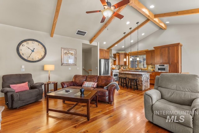 1391 Greystone Dr, Mccall, ID 83638 - living room featuring light wood-style floors, recessed lighting, beam ceiling, a ceiling fan, and high vaulted ceiling