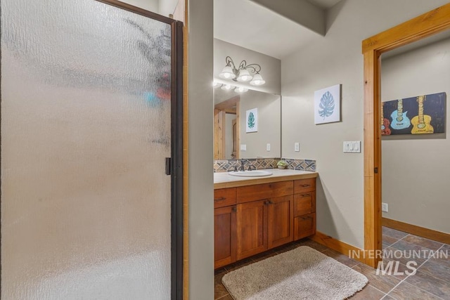 1391 Greystone Dr, Mccall, ID 83638 - bathroom with a stall shower, tile patterned flooring, vanity, tasteful backsplash, and baseboards
