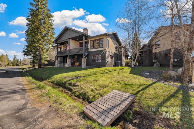 1391 Greystone Dr, Mccall, ID 83638 - rear view of house with a lawn, a chimney, a balcony, and central air condition unit