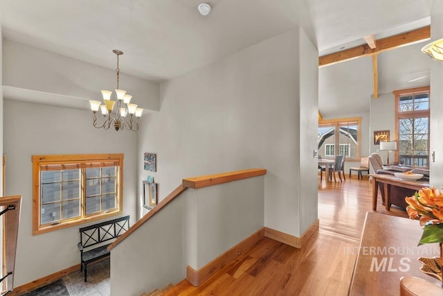 1391 Greystone Dr, Mccall, ID 83638 - hall featuring an upstairs landing, a chandelier, baseboards, and wood finished floors