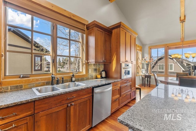 1391 Greystone Dr, Mccall, ID 83638 - kitchen featuring stainless steel appliances, a sink, lofted ceiling, light wood-type flooring, and backsplash