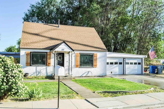 611 E Hawaii Ave, Nampa, ID 83686 - view of front facade with concrete driveway, a shingled roof, a front lawn, an attached garage, and stucco siding