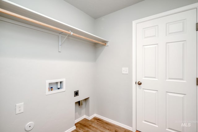 clothes washing area featuring laundry area, baseboards, wood finished floors, washer hookup, and electric dryer hookup