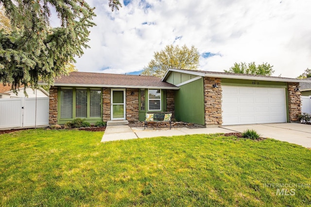 single story home featuring a garage, a front lawn, fence, stone siding, and concrete driveway