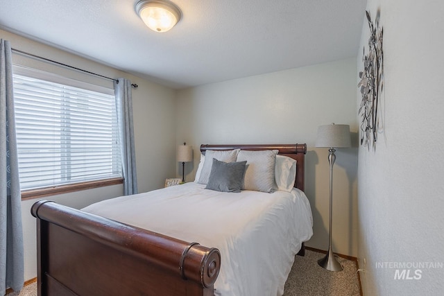 carpeted bedroom with baseboards