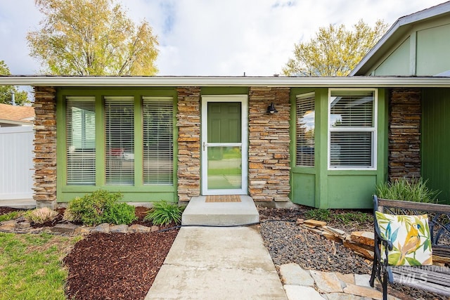 doorway to property featuring stone siding